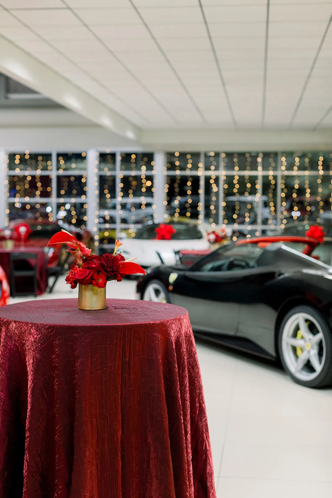 Deep red floral centerpiece at a Ferrari of Denver holiday event