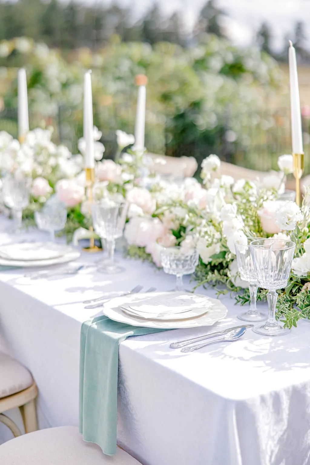 Bride holding a pastel blue, blush pink, and white wedding bouquet at Greystone Castle