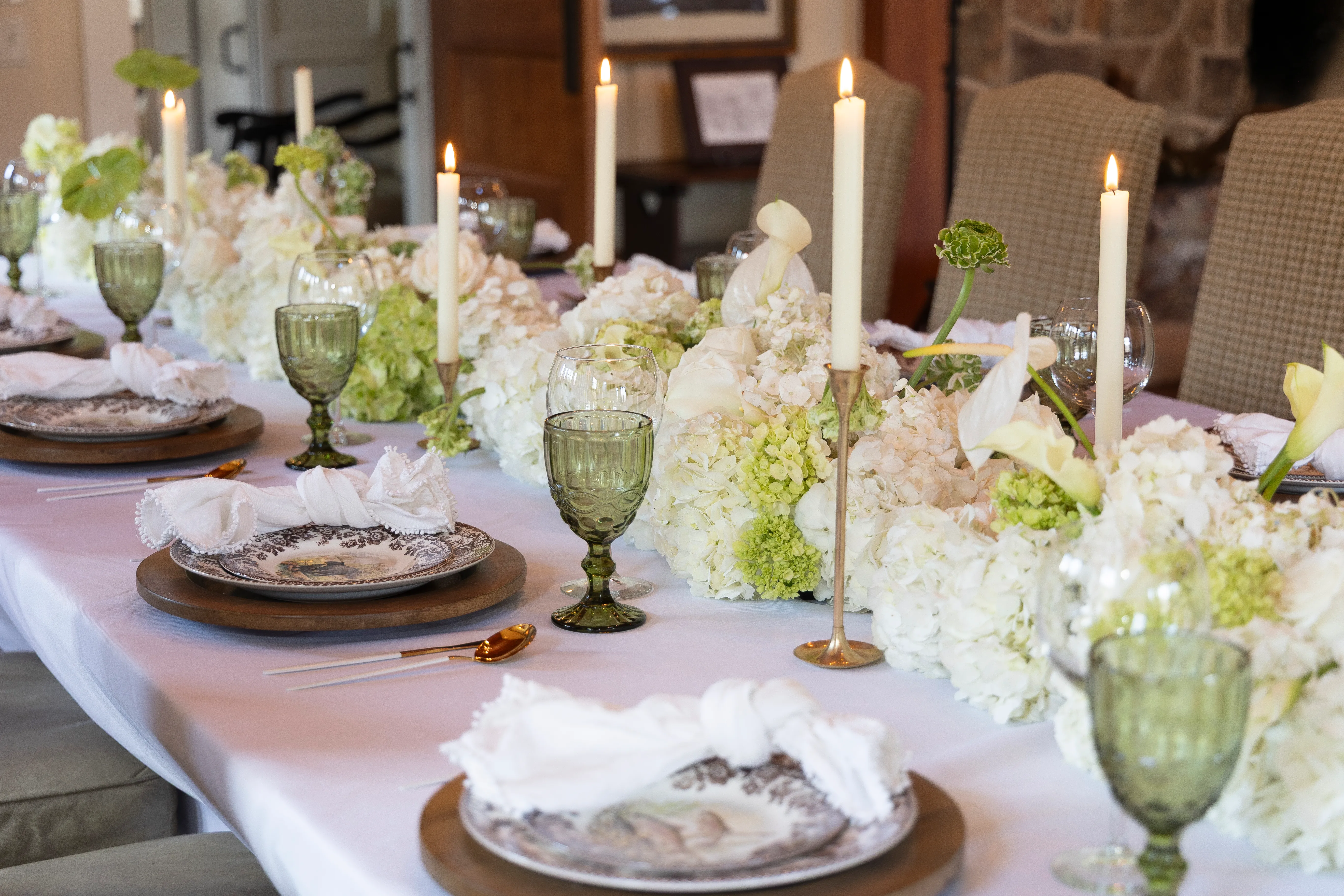 Cascading white and chartreuse table arrangement with hydrangeas and calla lilies
