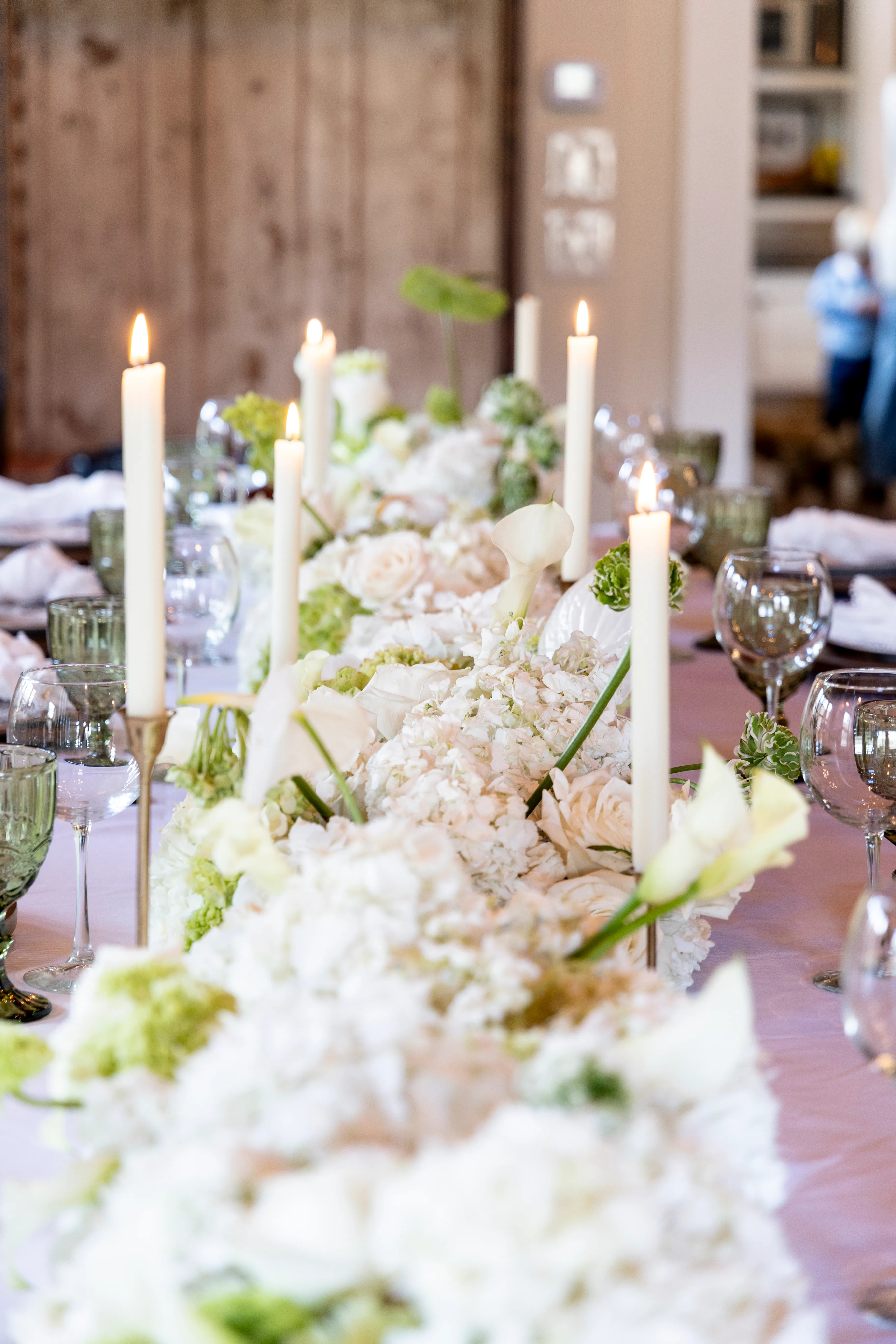 White and chartreuse floral runner with calla lilies and taper candles