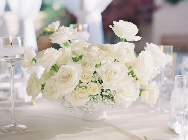 White rose and baby's breath centerpiece with candles