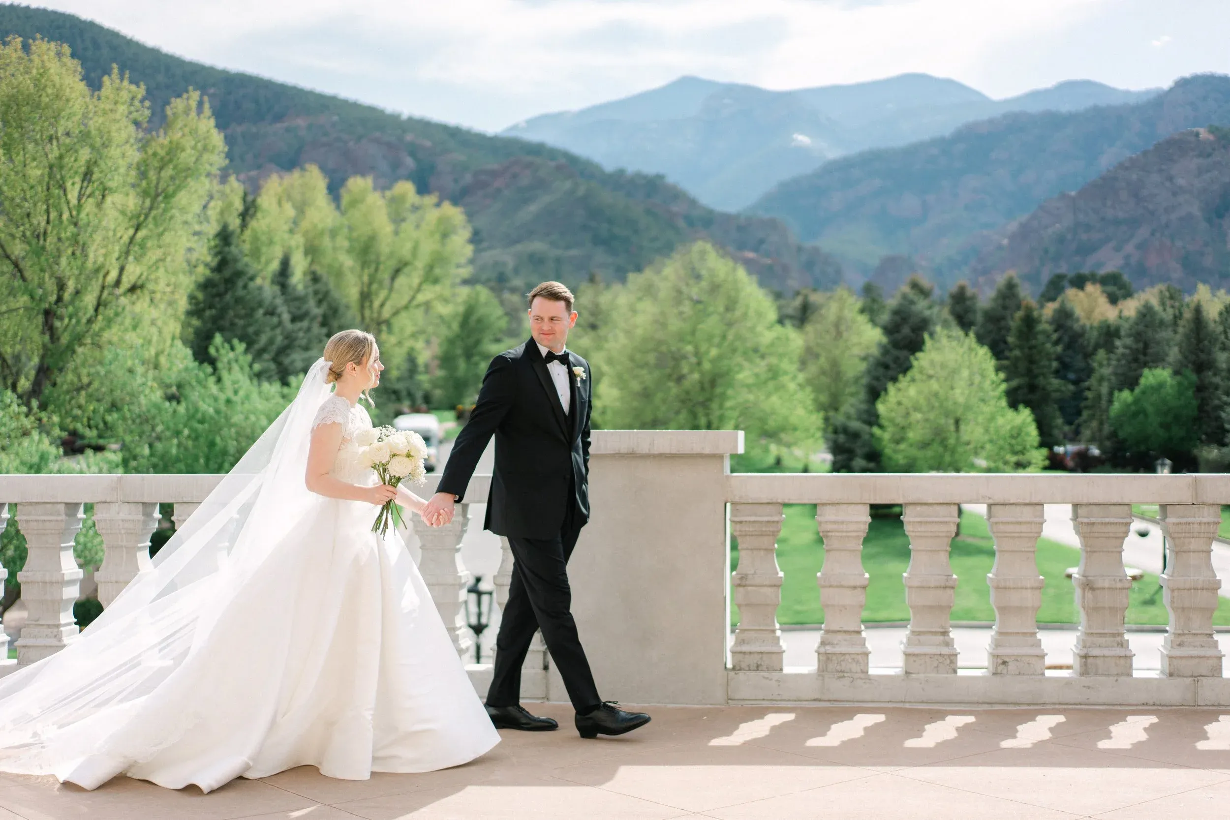 Bride and groom walking together with a mountain backdrop