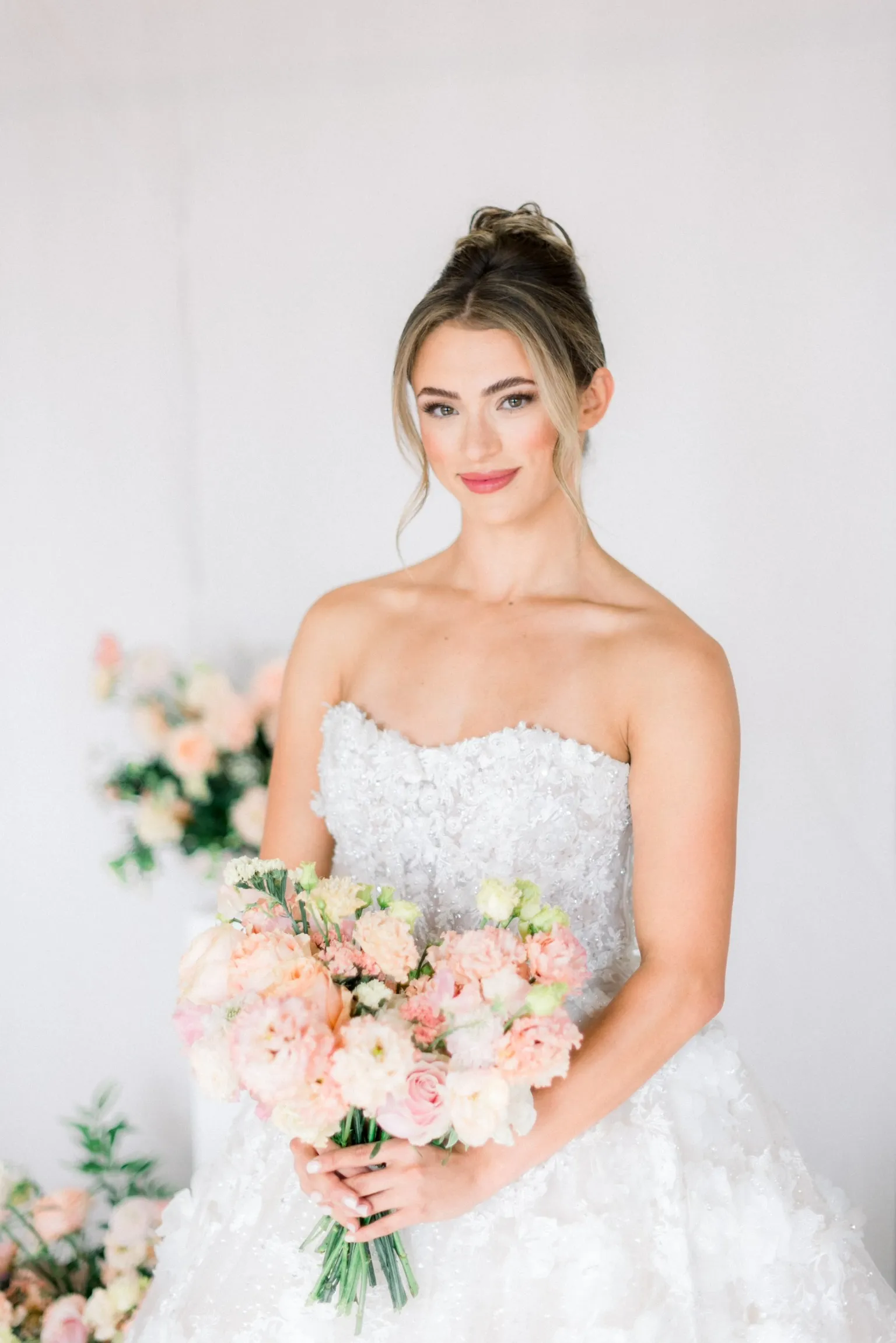 Bride holding a pink and white floral bouquet