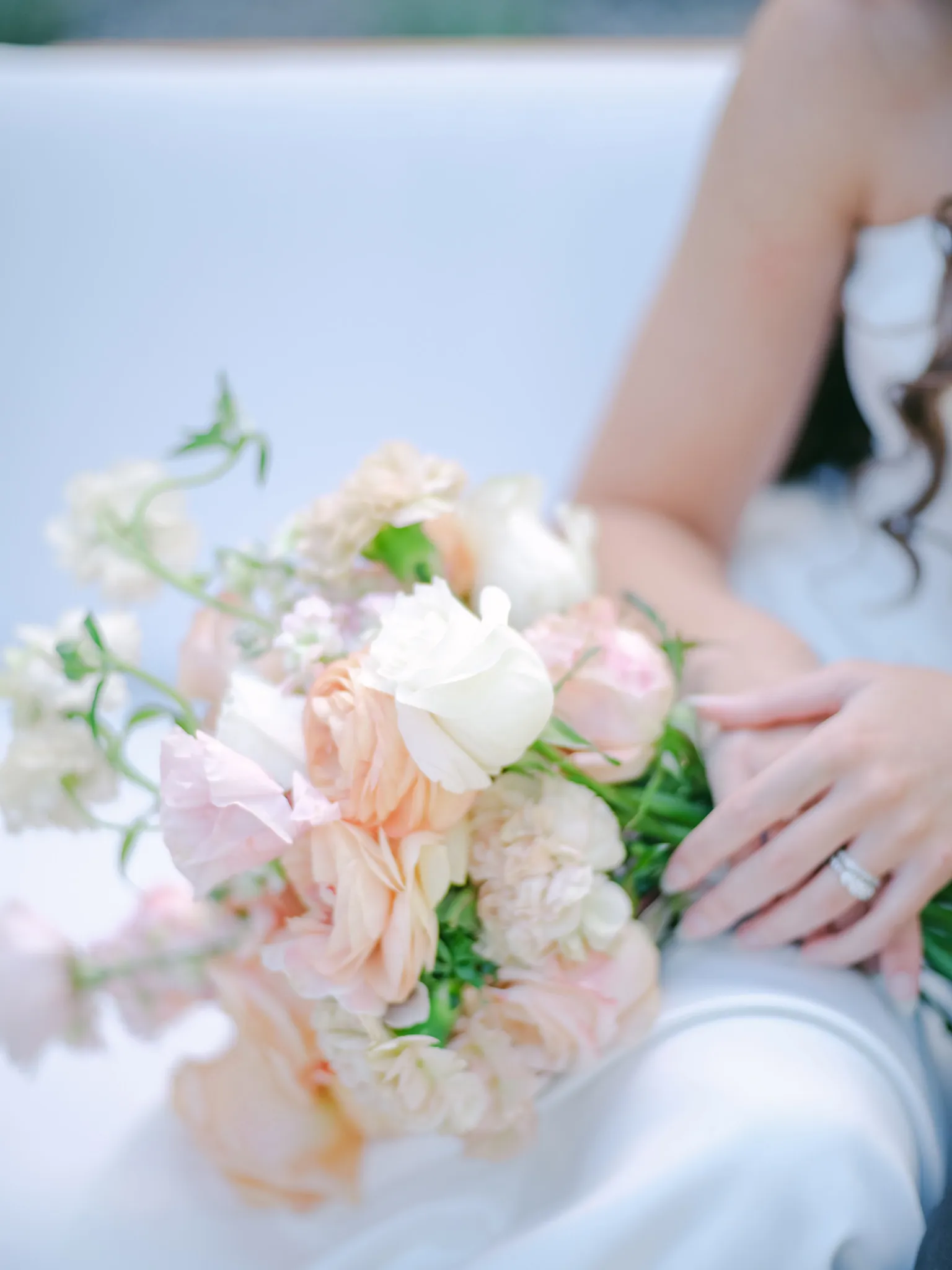 Bride holding a blush and white wedding bouquet