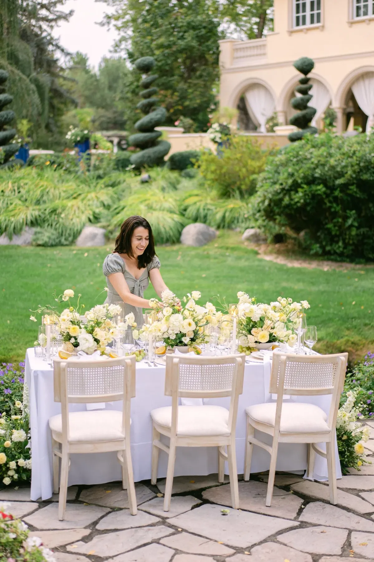 Outdoor garden wedding table with white floral arrangements