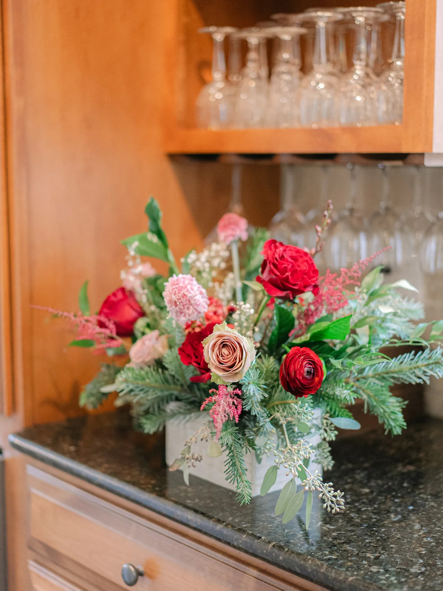 Red and pink flowers with seasonal greenery